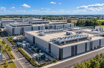 Aerial view of a modern European data center campus with cooling systems and electrical infrastructure, illustrating OVHcloud's 110MW spare power capacity for cloud and AI expansion.